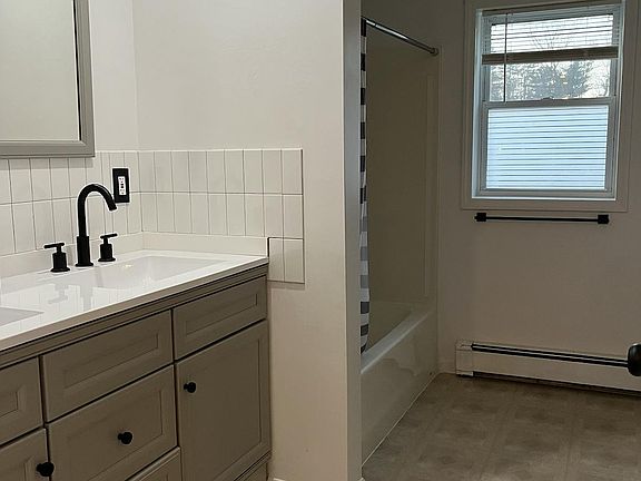 Large bathroom with tub/shower combo and plenty of storage.