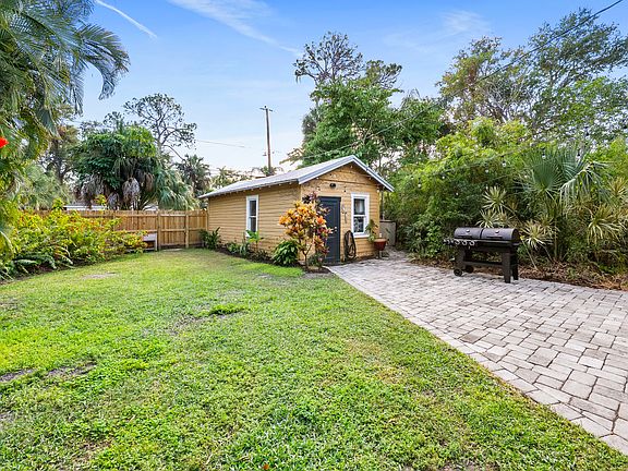 Backyard with lawn, fencing, and detatched garage