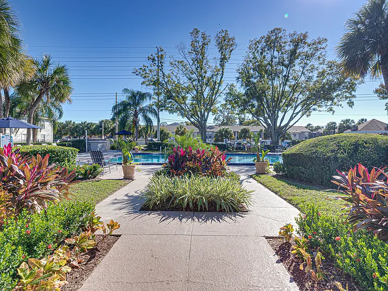 Beautifully maintained walkway surrounded by lush landscaping throughout the community.