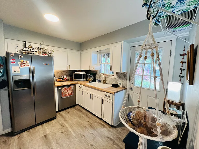 Beautiful modern kitchen with white cabinets and high end stainless steel appliances!