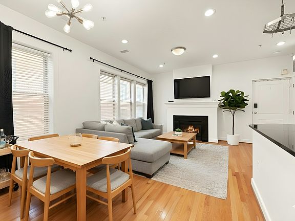 Sun-filled top-floor living with skylight, hardwoods, high ceilings, and gas fireplace