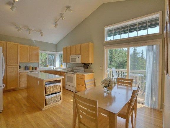 Eating space in the kitchen makes daily living easy. Territorial view from Trex deck through double sliding doors.