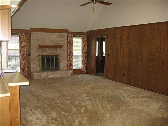  Large family room with wood burning fire place and high ceilings.