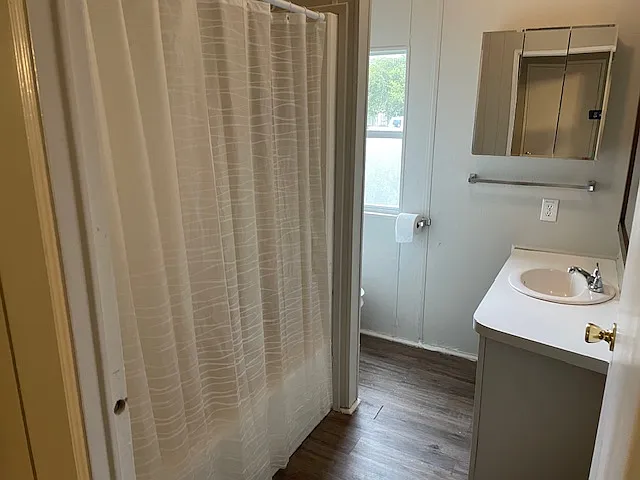 Full Bath with single vanity and tub/shower combo.