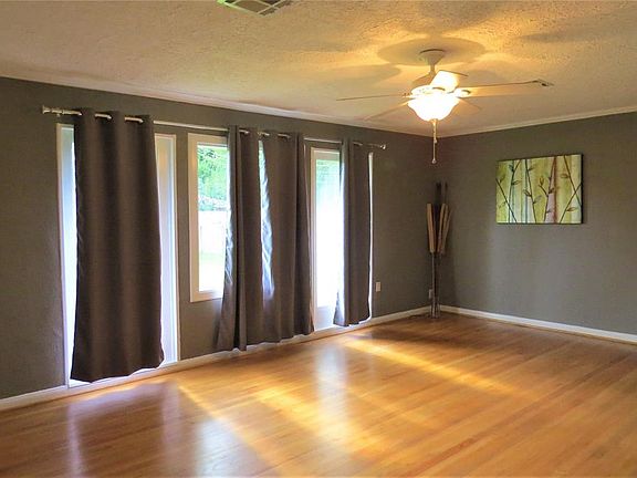 Another view of the living room. Notice the sparkling refinished hardwood floor and ceiling fan.