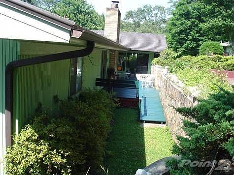 Back patio joining sun room with hot tub