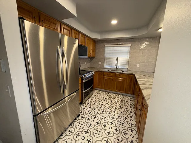 Stainless steel appliances, electric stove top, double oven, microwave and air fryer combo, with a dishwasher.