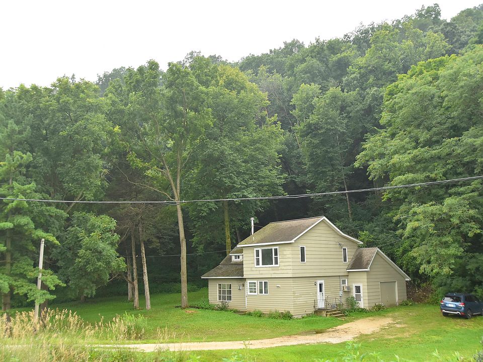 House, lawn, and 6-acre wooded hillside. Distance to edge of Luther College is 0.7 miles; distance to Decorah Post Office, City Hall, Law Enforcement Center/Fire Dept, and downtown Decorah is 1.2 miles.