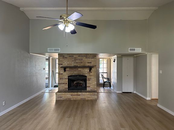 Beautiful living that is wide open perfect for entertaining. Open to painting fireplace.