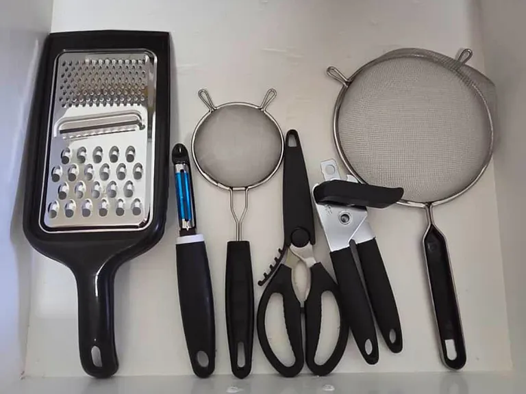 Cooking essentials including grater, scissors, and colanders