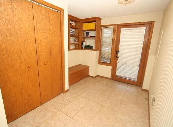 Foyer features ceramic tile floors and bench seat.