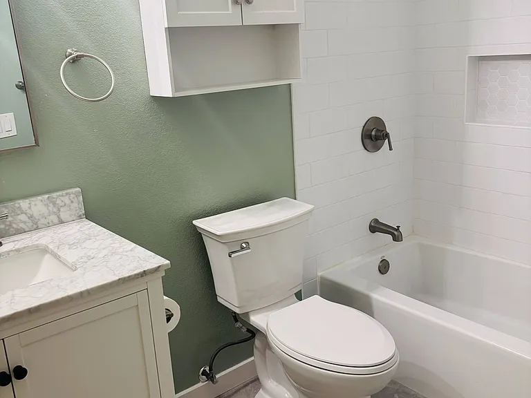 Hallway bathroom with tub