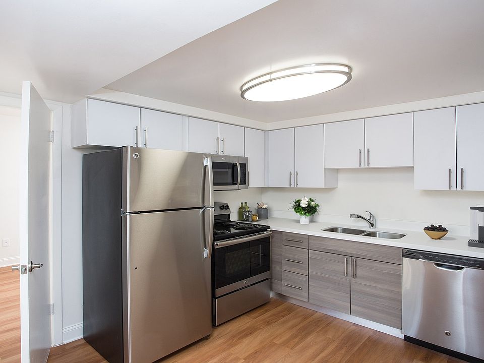 Renovated kitchen with quartz countertops and stainless steel appliances