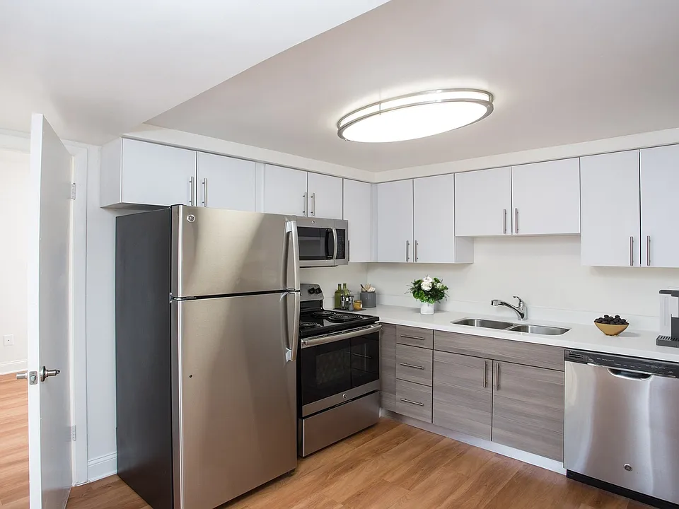 Renovated kitchen with quartz countertops and stainless steel appliances