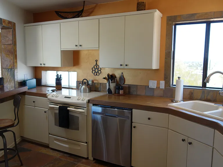Fully equipped kitchen with full size fridge, 5 burner electric range with convection oven, 3 rack dishwasher, garbage disposal, microwave. Dishes, utensils, cookware, bakeware, serving pieces and gadgets galore.