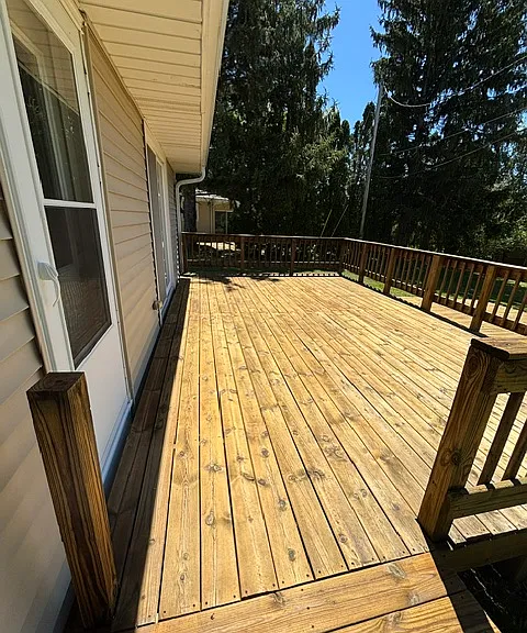 Back deck accessible from patio doors and door next to kitchen for easy access to grill out.