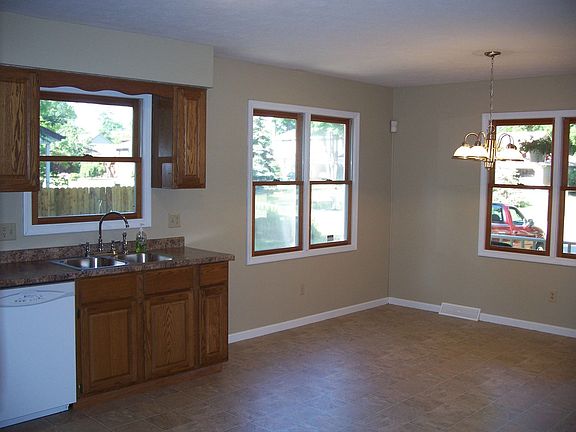 other side of large kitchen showing many windows and new light fixture