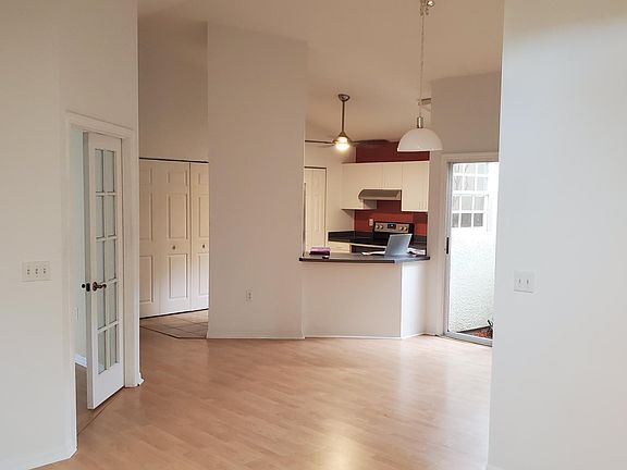 Great room looking toward the dining area and the kitchen. Third bedroom is on the left.