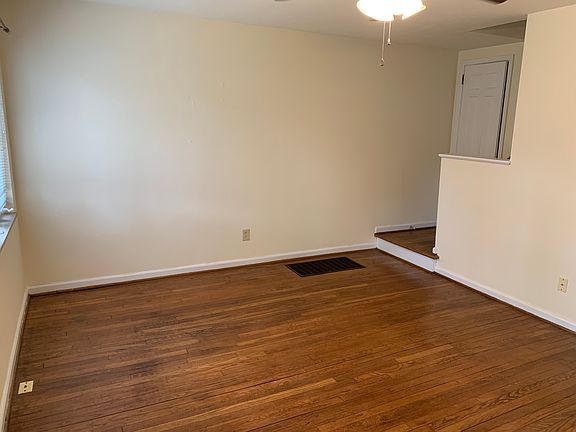 Living room, coat closet and staircase.