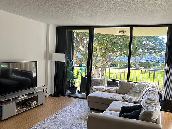 Floor to ceiling windows. 55" television. Large sectional.