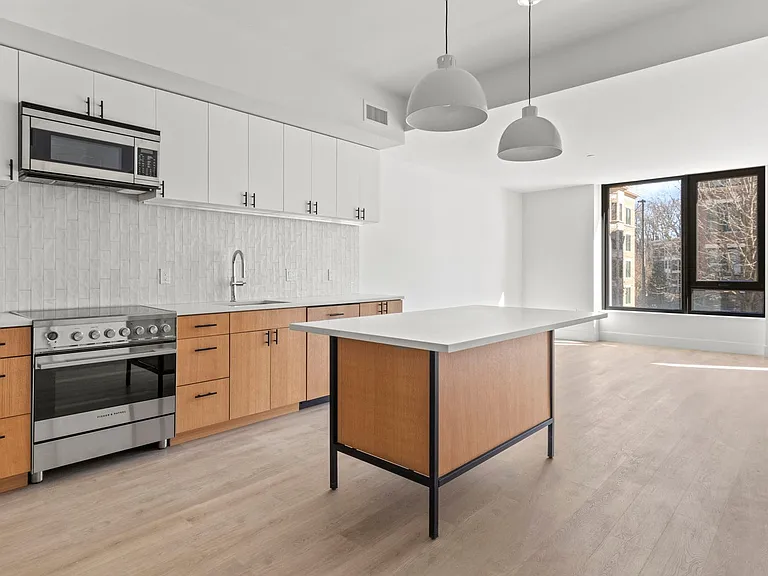 Spacious kitchen interiors with a stand alone kitchen island.