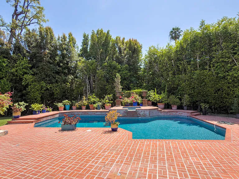 Tranquil pool and spa nestled among towering trees create resort-like privacy at this Beverly Hills luxury rental, 1094 Garden Lane, 90210.