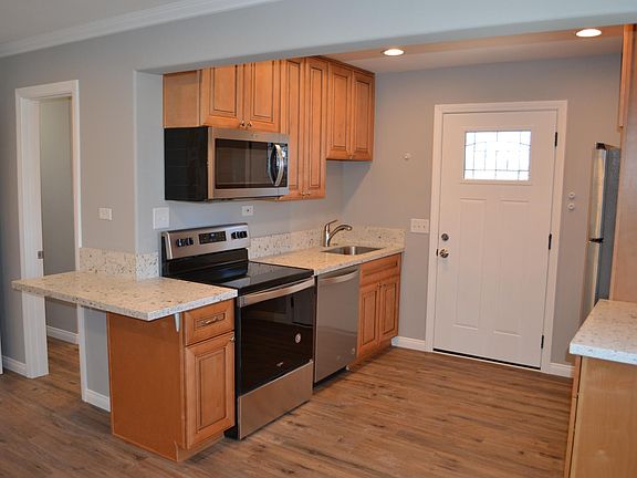 Fully renovated kitchen with quartz countertops and stainless steel appliances.