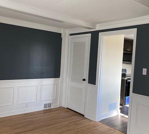 Dining room with doorway into kitchen. Closed door is a closet.