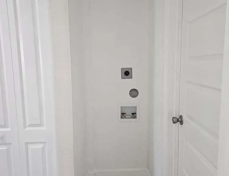 Laundry area with electrical and dryer vent connection designed for a 24" stackable washer/dryer only
