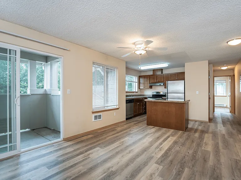 Step into this bright and open living space! __ Featuring a modern kitchen with a central island, wood-style flooring, and access to your private balcony. The perfect blend of style and comfort! Step into this bright and open living space! __ Featuring a 