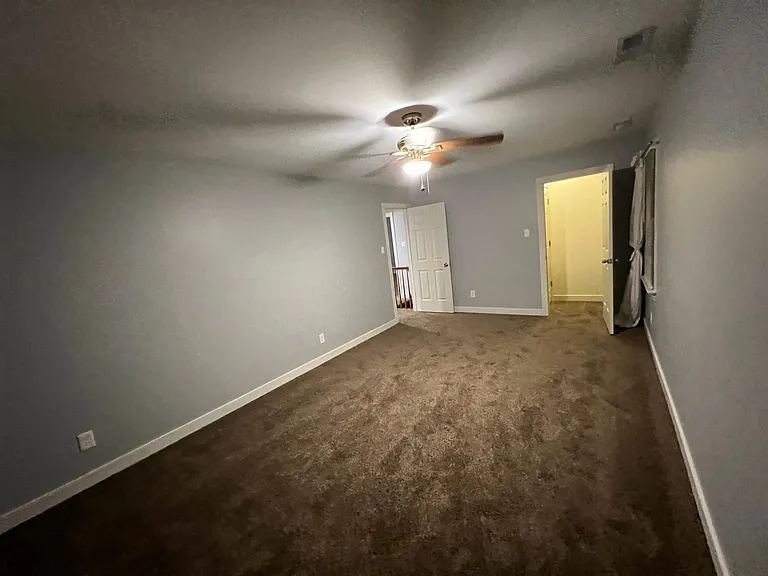 Bedroom 1 photo, door to hallway on the left, and 3rd closet of the room on the right, also stairwell to the attic