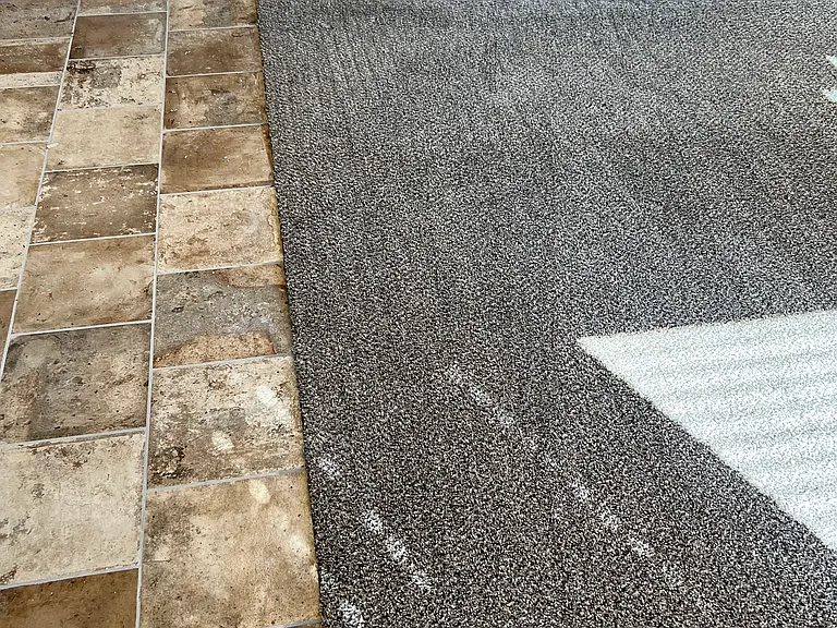 Tile and carpet off of kitchen into the living room