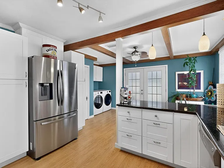 Bright kitchen with sleek stainless steel appliances, blending functionality and style.