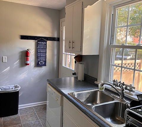 Kitchen with dishwasher, microwave, oven/stove and refrigerator.