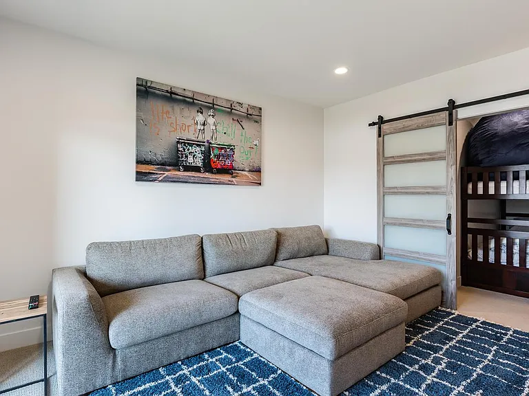 Apartment / Lower Floor living room / tv theatre room with views of the bunk room for guests with kids. Apartment sleeps 4 people easy.