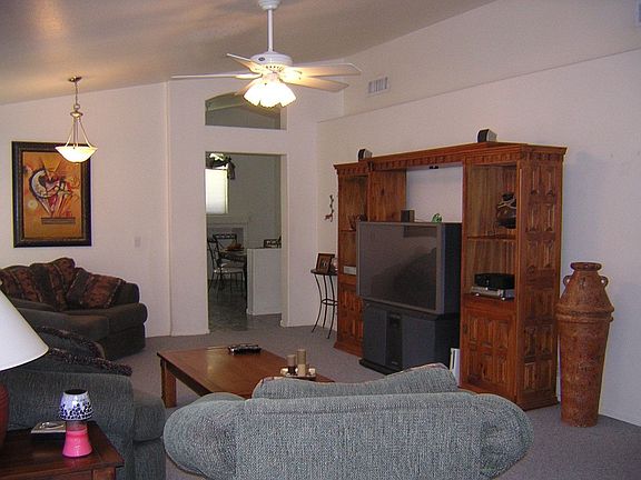 Open Great Room With Vaulted Ceilings and Custom Window Coverings