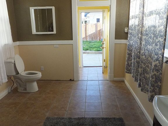 1/2 bath, laundry room, and mud room leading to backyard