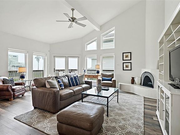 Enter this home to a gorgeous openliving/kitchen/dining concept with wrap-around windows leading to the beachside decking, high vaulted ceilings with paintedexposed beams, wood-burning fireplace & Luxury Vinyl Plank cork backed flooring throughout.