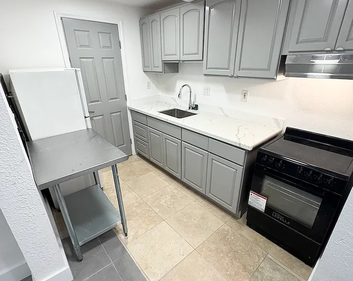 Kitchen with electric stove and oven