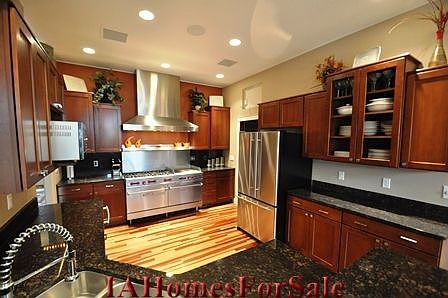 Kitchen has granite counters and cherry cabinets.
