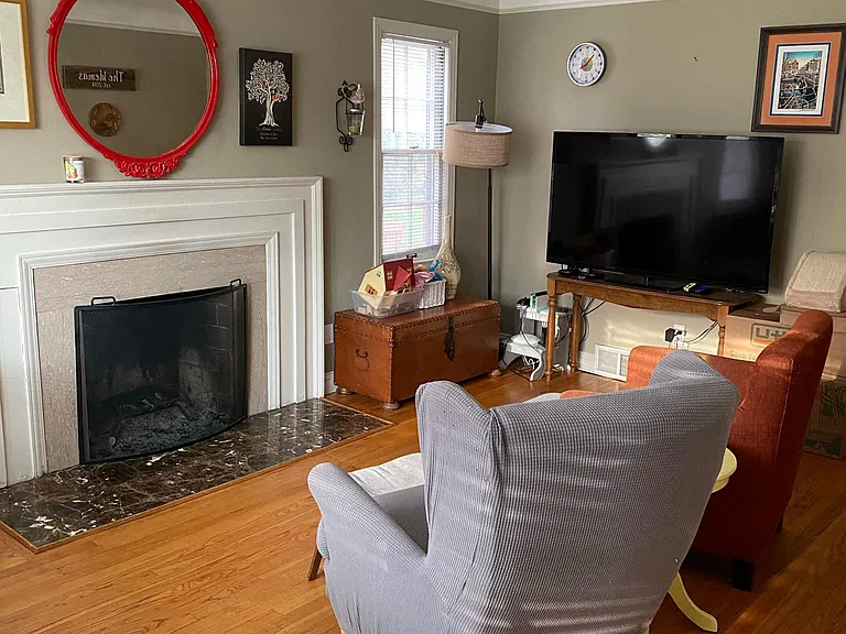Living Area with working fireplace. Wood flooring throughout main floor.