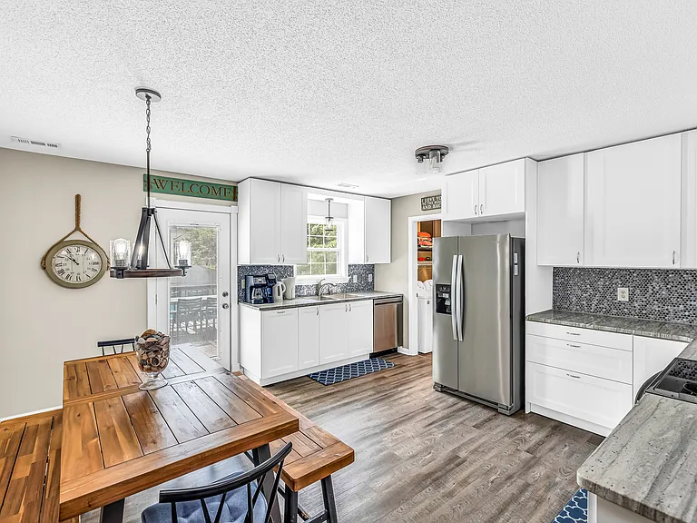 Kitchen view off Living Room. Laundry Room is right off Kitchen as well as back door to deck and backyard.