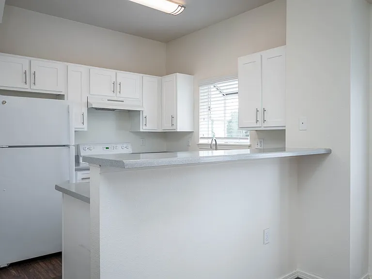 Village at Main Street | 2x2 Kitchen with White Cabinetry and Appliance and Eat In Counter