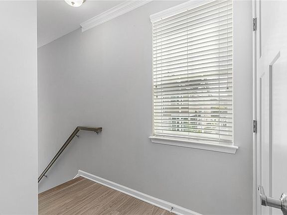 Stairway To Front Door.  Stairs Leading To Garage On Right