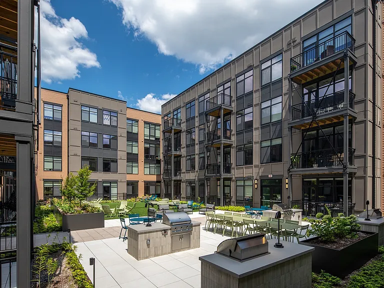 Courtyard Equipped with Grills and Outdoor Seating
