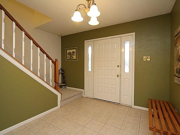 This spacious foyer features, tile flooring, 2 side lights providing additional natural lighting and