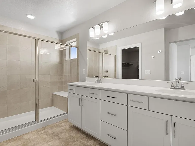 primary bathroom with dual sinks & walk-in shower