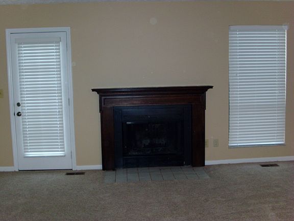 Living room fireplace. Access to patio.