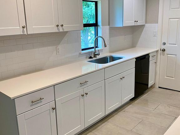 Kitchen all new cabinets countertops and tile.