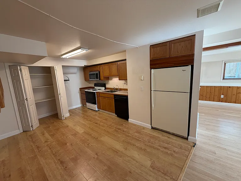 kitchen includes dishwasher, oven, microwave, and refrigerator. Walk in pantry.